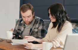 Couple looking at car insurance renewal, 2025